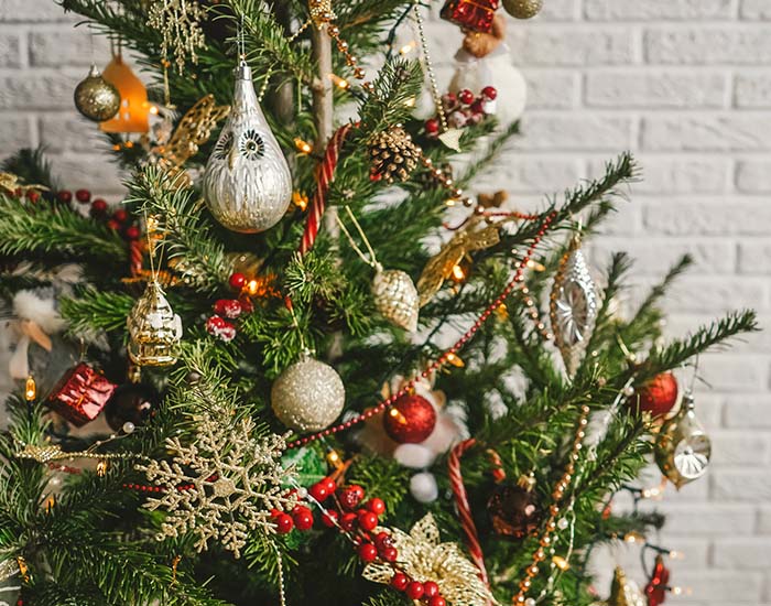 Beautiful decorated Christmas tree on white wall background