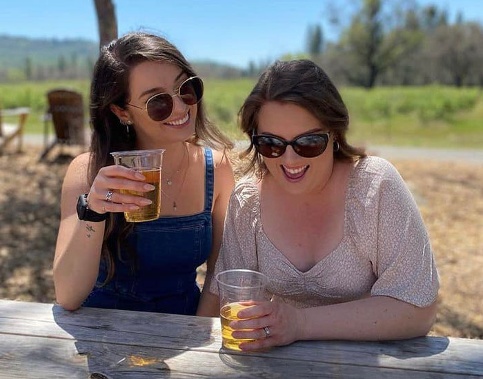 teo friends tasting cider drinks